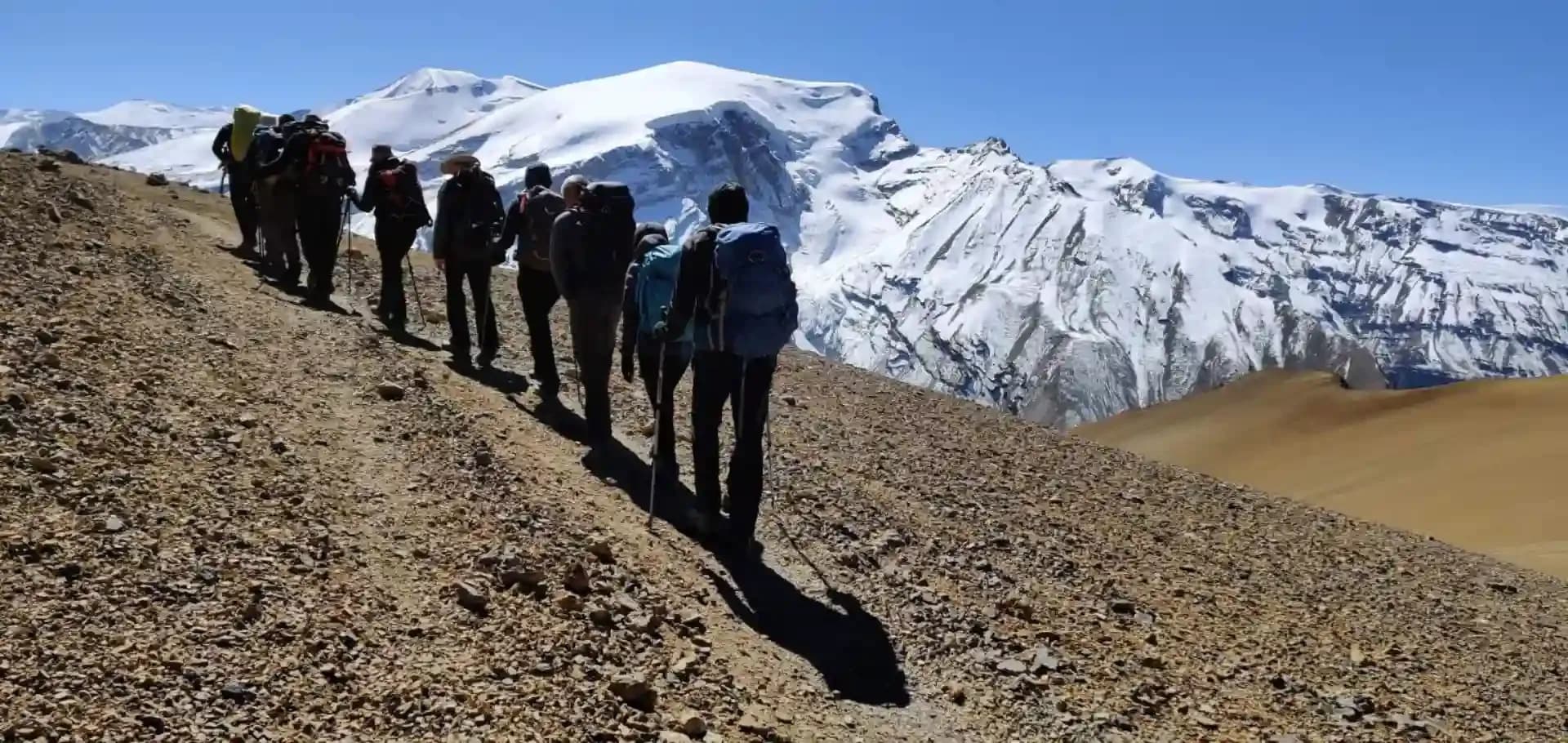 Trekkers walking through the Nepal Himalaya on the Saribung Pass Trek in Mustang